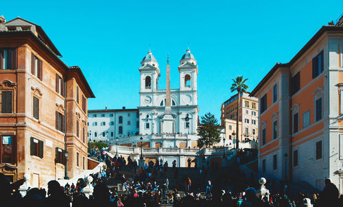 Group of people in front of buildings in city