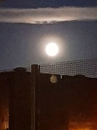 Illuminated building against sky at sunset
