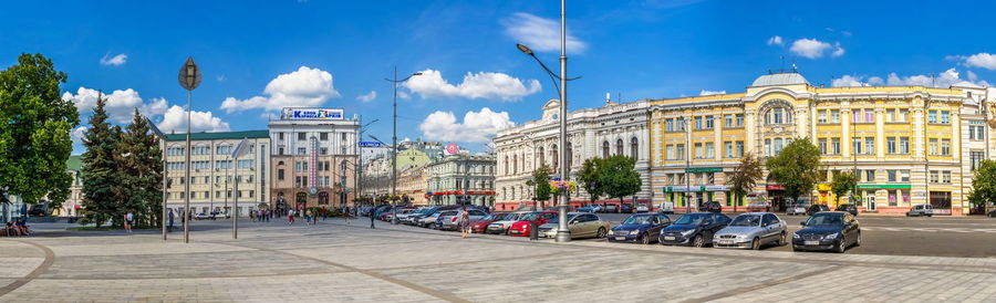 Buildings in city against blue sky