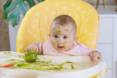 Portrait of cute baby boy eating food