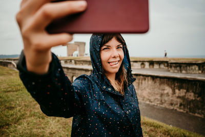 Smiling young woman using mobile phone