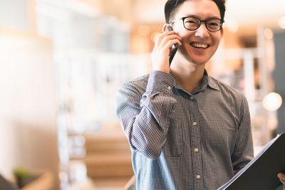 Mid adult man using mobile phone