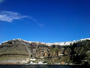 Scenic view of mountains against blue sky