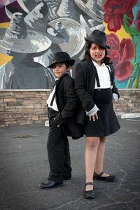 Full length portrait of friends standing outdoors