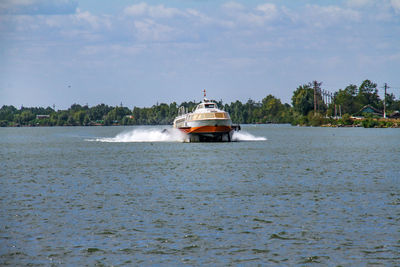 Boat sailing on sea against sky