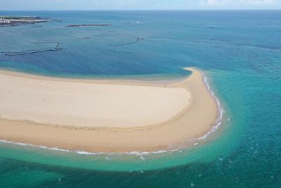 High angle view of sea shore against sky