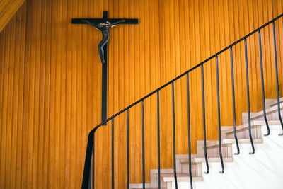 Metal railing against wooden wall in church