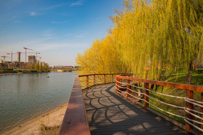 Footpath by river against sky