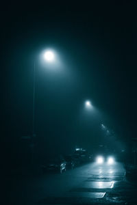 Illuminated street light in city at night