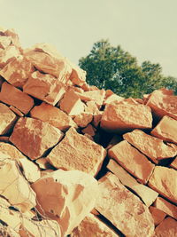 Stack of firewood against sky