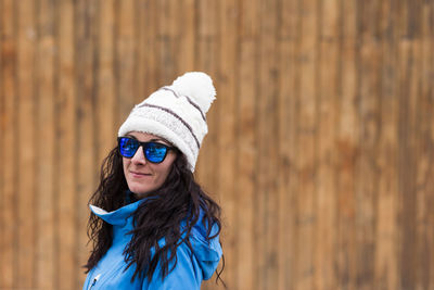 Portrait of woman wearing hat standing in winter