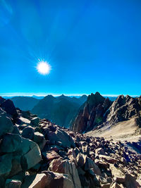 Scenic view of mountains against blue sky