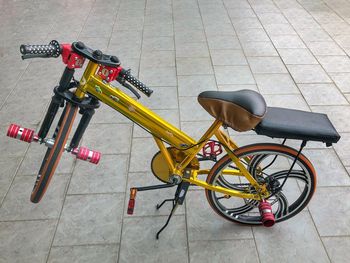 High angle view of bicycle parked on footpath