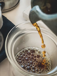 Close-up of coffee pouring into glass