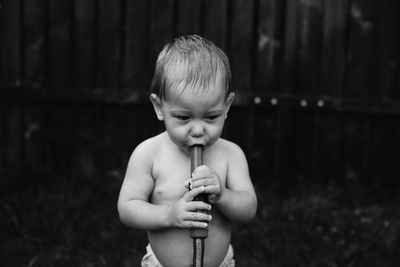 Portrait of cute boy holding camera