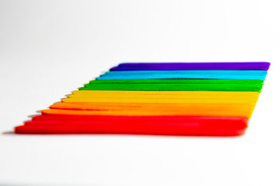 Close-up of multi colored pencils against white background