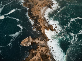 High angle view of water flowing through rocks