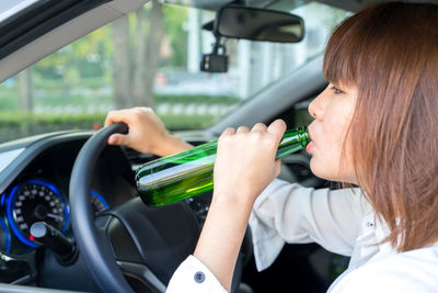 Rear view of woman sitting in car