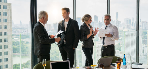 Group of people using phone while standing on table