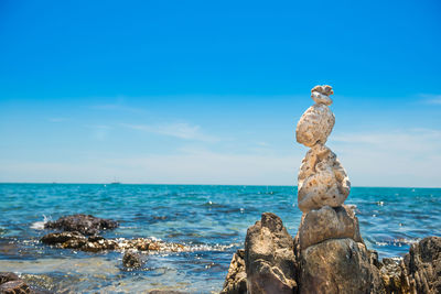 Scenic view of rocks on beach against sky