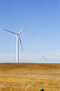 Wind turbines in colorado against blue sky