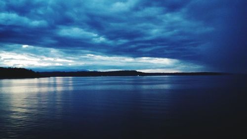 Scenic view of calm sea against cloudy sky