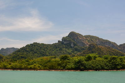 Scenic view of sea and mountains against sky