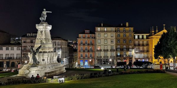 Statue of buildings in city at night