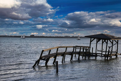 Pier over sea against sky