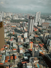 High angle view of modern buildings in city against sky