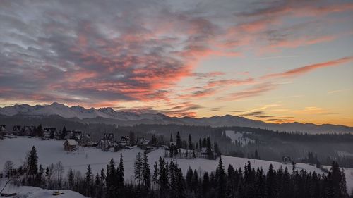 Scenic view of snowcapped mountains against sky during sunset
