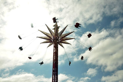 Low angle view of amusement park ride against sky