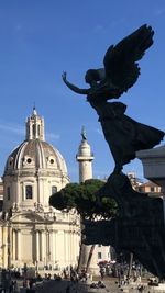 Statue of temple against building