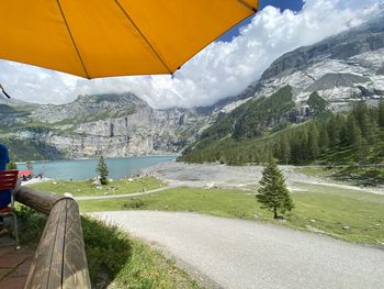 Scenic view of lake by mountains against sky