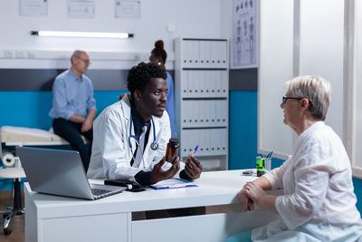 Doctor examining patient in clinic