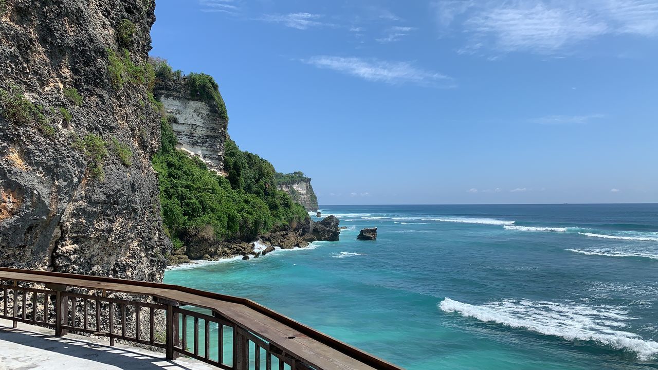 SCENIC VIEW OF SEA AGAINST SKY SEEN THROUGH ROCKS