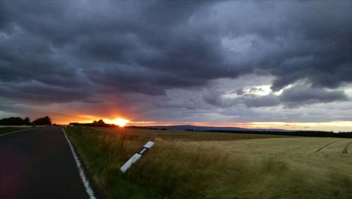 Scenic view of landscape against cloudy sky