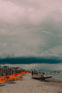 Boats moored on beach against sky