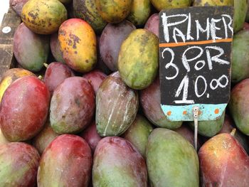 Close-up of price tag on mango fruits at market stall