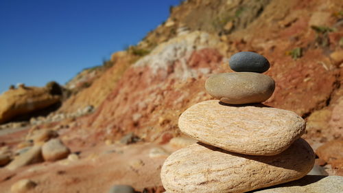 Stack of rocks against clear sky