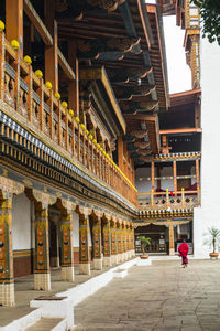 Rear view of woman walking in historic building