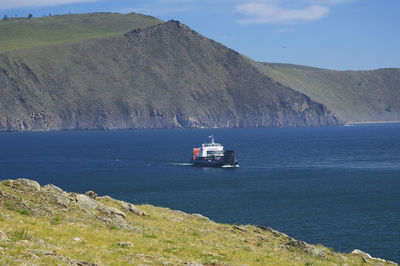 Scenic view of sea and mountains against sky