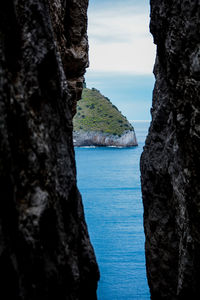 Scenic view of sea and rock formation against sky