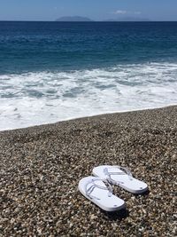 Close-up of sea shore at beach against sky