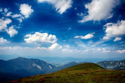 Scenic view of mountains against cloudy sky