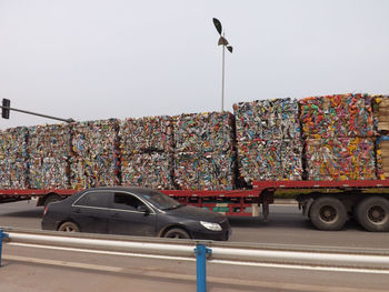 Vehicles on road against clear sky