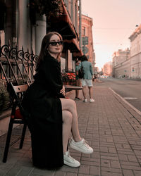 Portrait of young woman standing on street