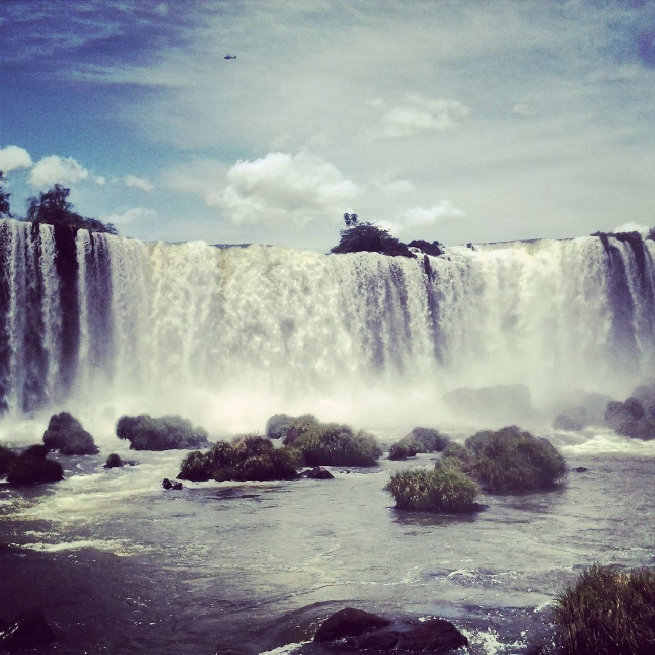 water, motion, waterfall, beauty in nature, scenics, long exposure, flowing water, splashing, power in nature, nature, flowing, surf, waterfront, rock - object, famous place, travel destinations, tourism, sky, travel, idyllic