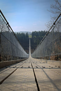 Footbridge against sky, hanging bridge
