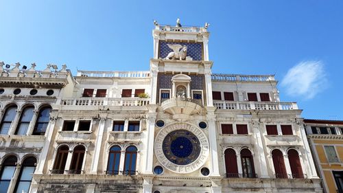 Low angle view of historical building against blue sky